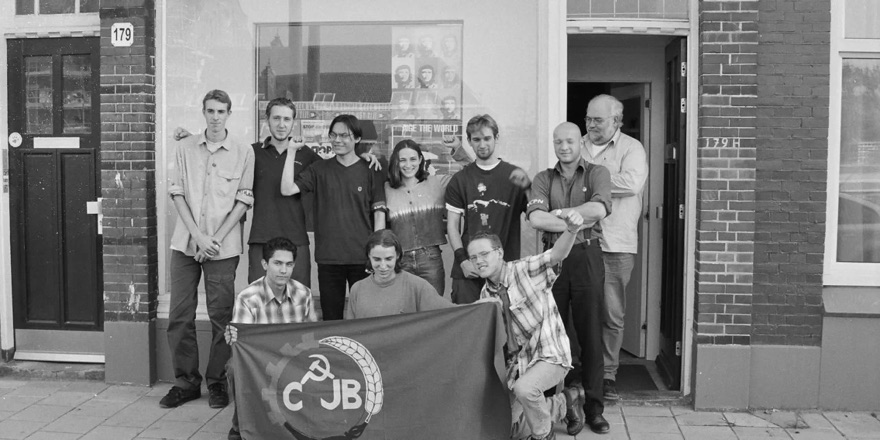 Group photo of the newly founded CJB in front of the NCPN party office, with the CJB flag