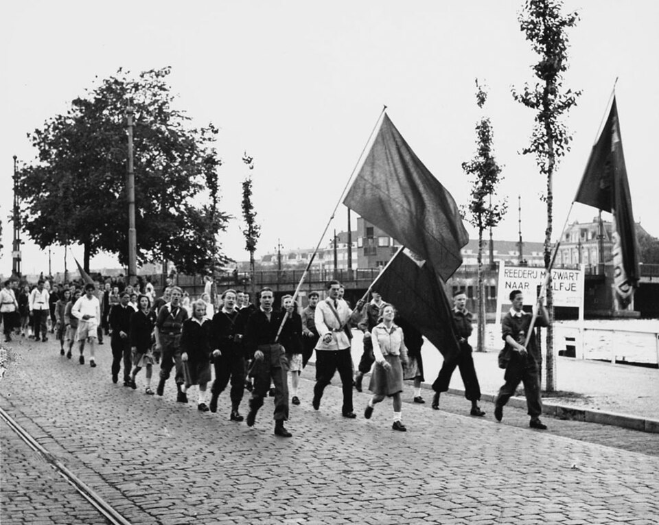 Young ANJV members with signs demonstrating on the Amsteldijk in Amsterdam, 1948