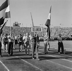 The Dutch team with Dutch flags enters the stadium in Bucharest behind the OLANDA sign, 1953